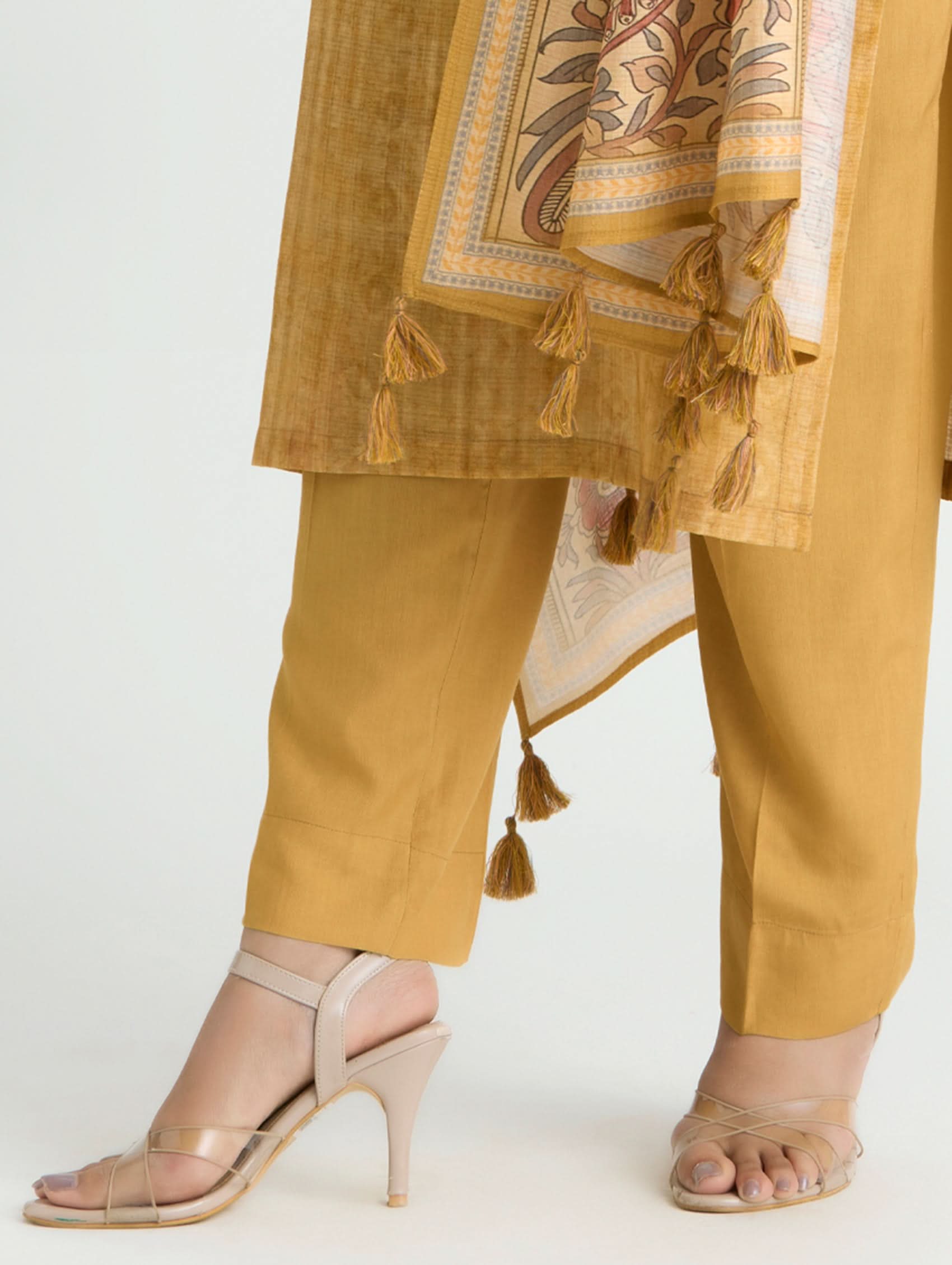 Mustard yellow traditional outfit with a patterned scarf on a white background