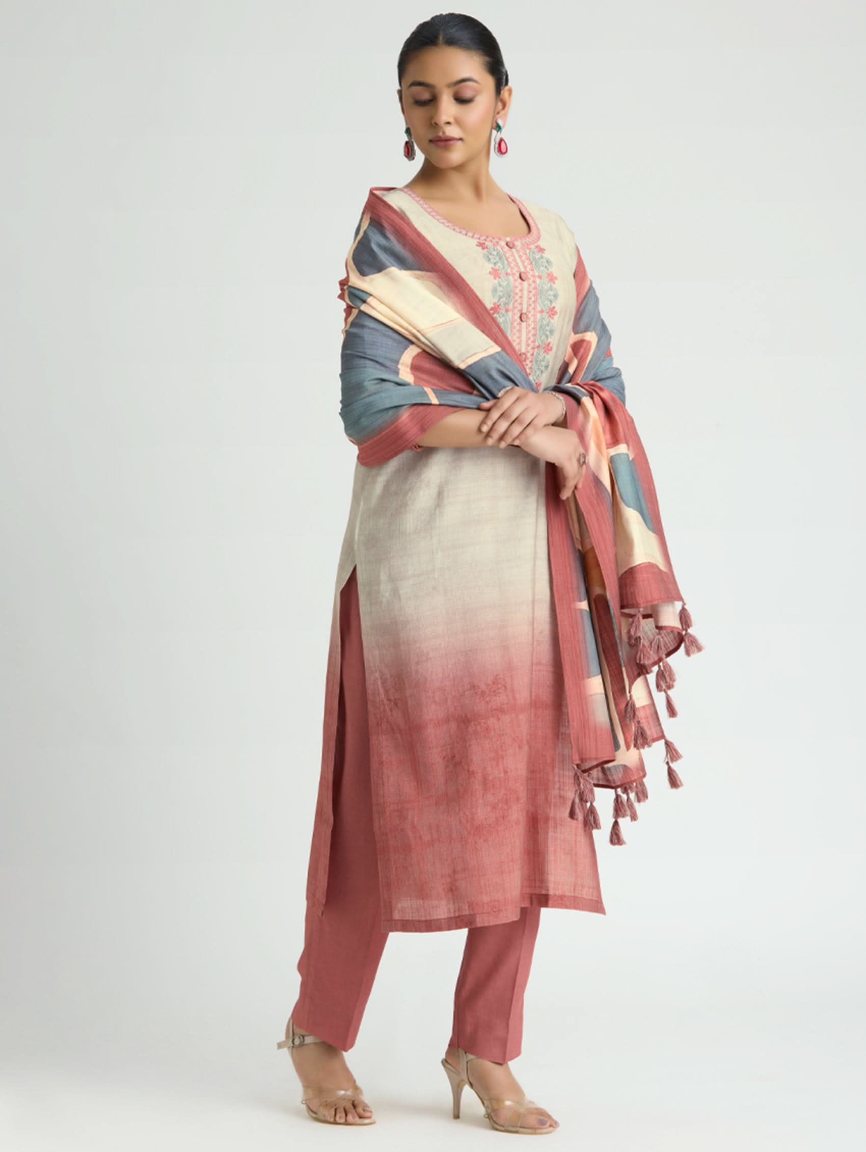 Woman wearing a traditional outfit with a colorful scarf on a white background