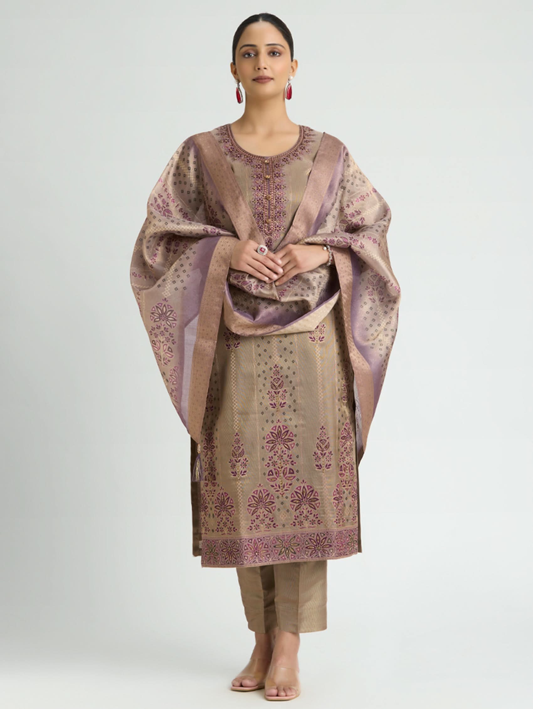 Woman wearing a traditional outfit with a patterned shawl on a white background