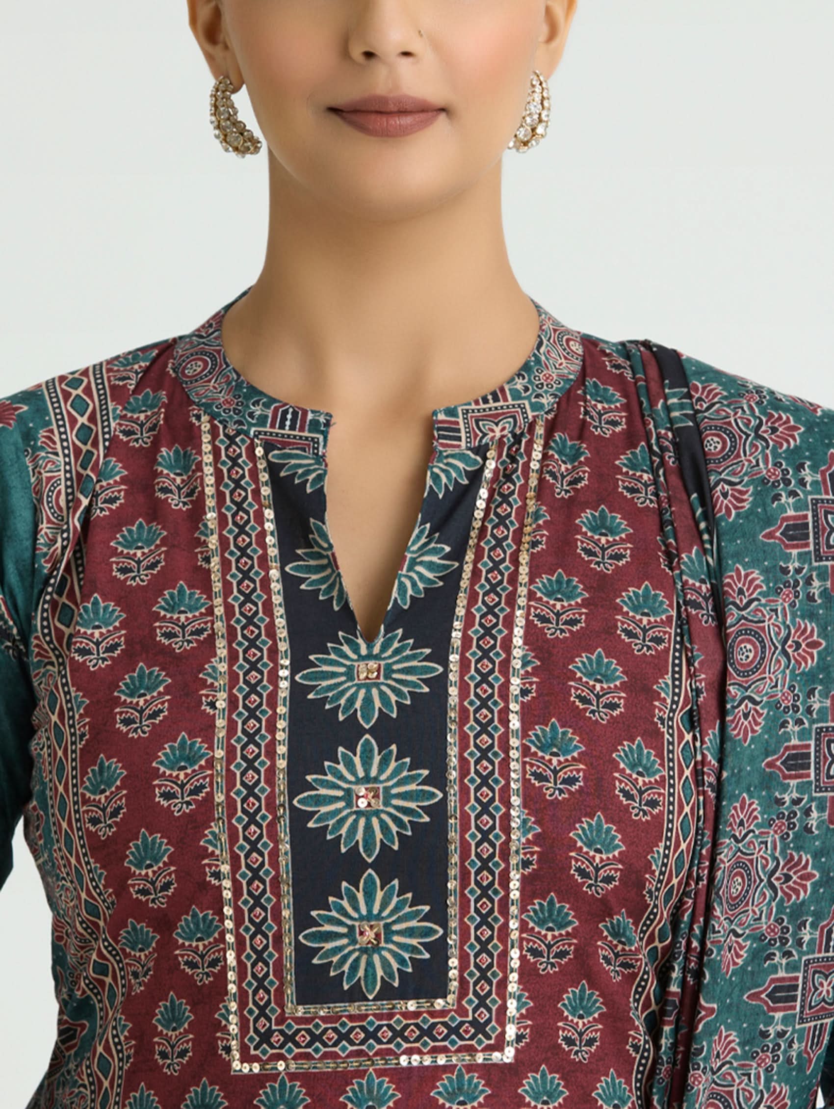 Traditional patterned garment with floral designs on a plain background
