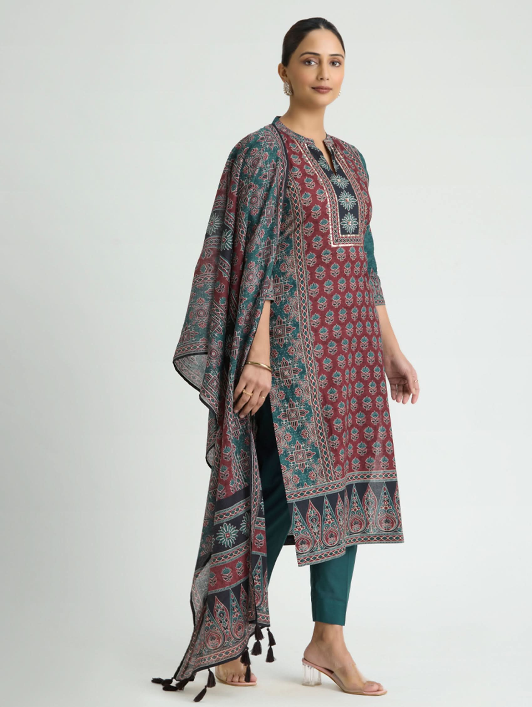 Woman wearing a patterned kurta with a plain background