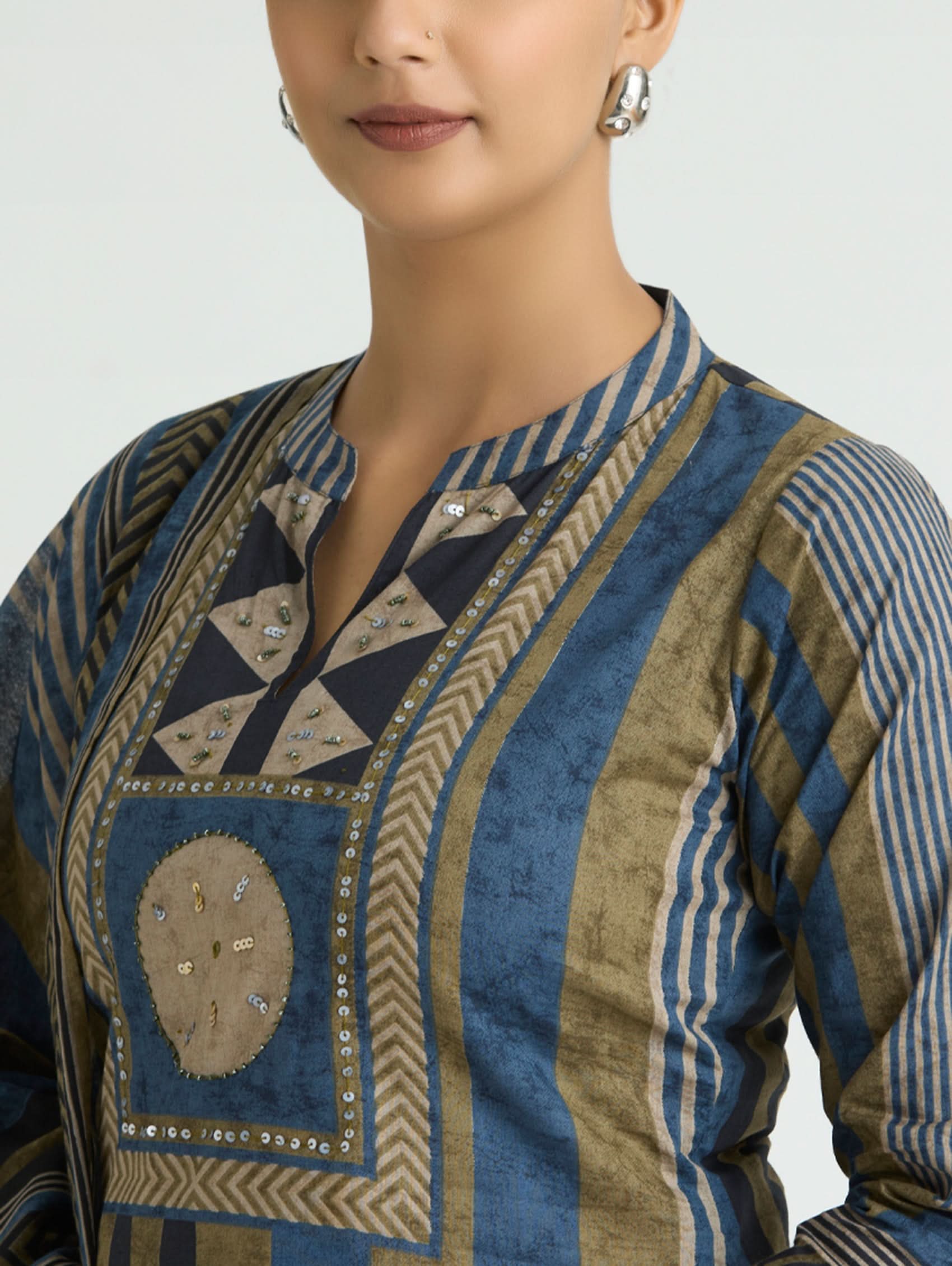 Traditional patterned garment with intricate designs on a plain background