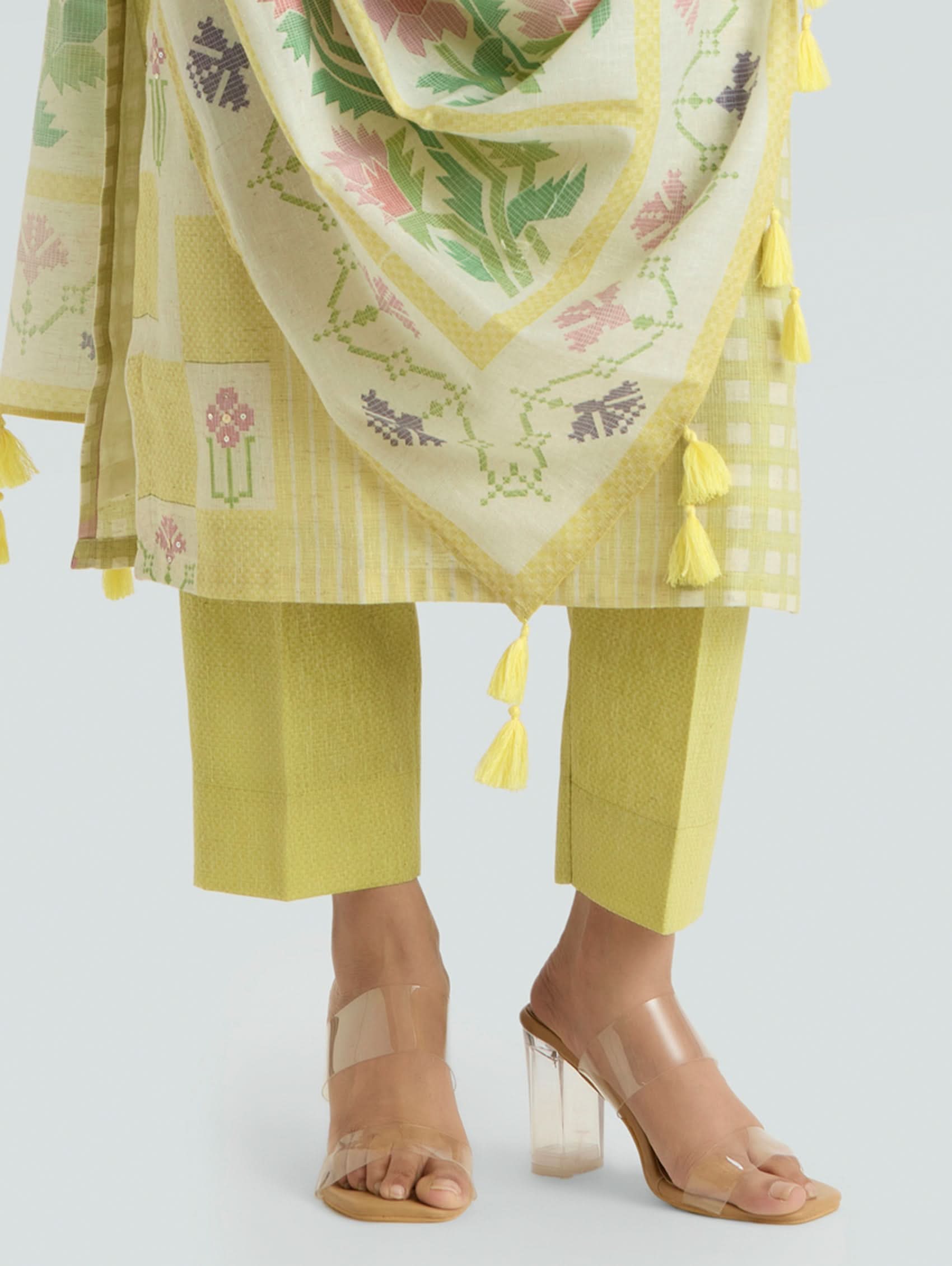 Yellow outfit with floral patterned dupatta on a white background