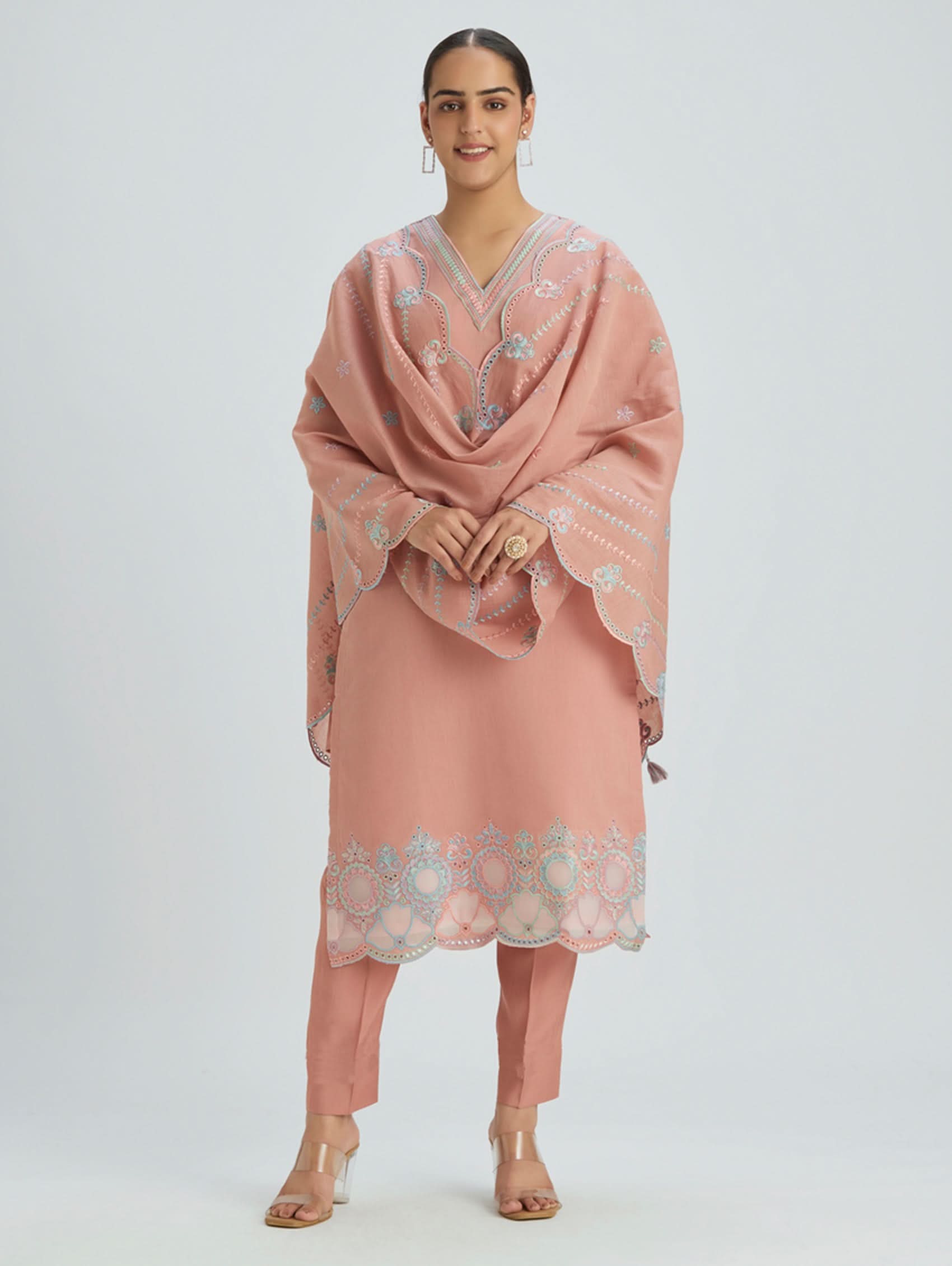 Woman wearing a pink traditional outfit with a matching Dupatta on a white background
