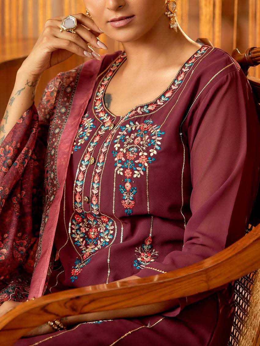 A woman standing in an elegant pose wearing a purple georgette suit with embroidered details and a dupatta with digital printed chanderi silk.