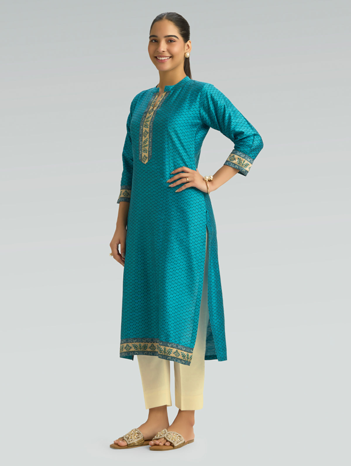 Dark cyan printed kurta with long sleeves, gold-trim cuffs, and side slit
