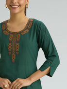 Green embroidered kurta worn by a model on a plain background