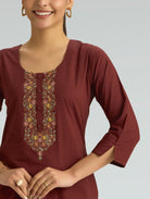 Maroon kurta with floral embroidery on a plain background