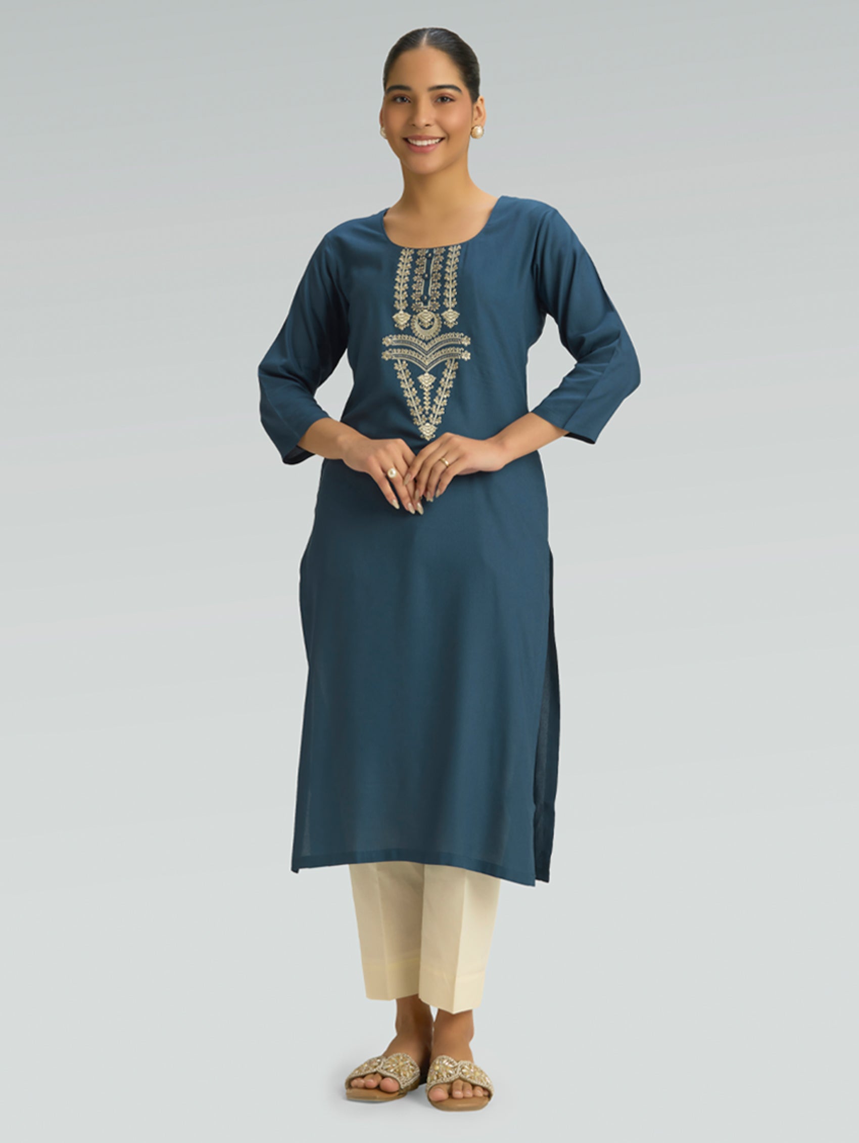 “Straight-fit blue kurta with round collar and computerized thread embroidery on a gray background.”