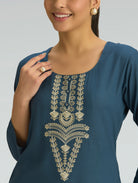Navy blue top with gold embroidery on a plain background