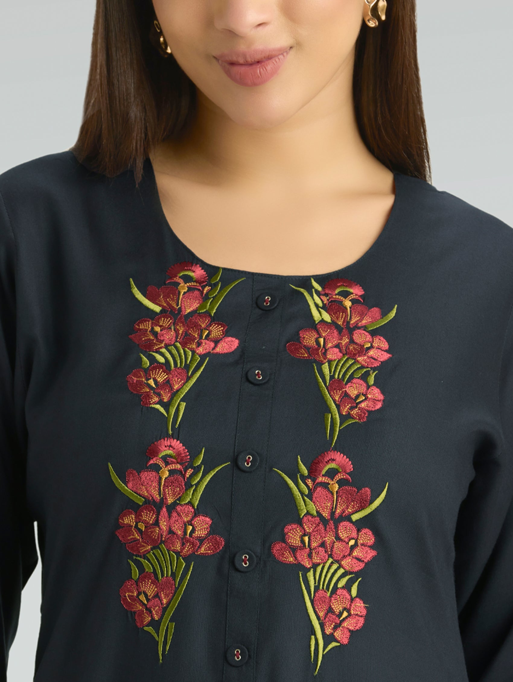 Navy blue top with floral embroidery on a plain background
