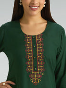 Green kurta with intricate embroidery on a plain background