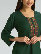 Green dress with embroidery on a plain background