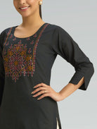Black kurta with intricate embroidery on a plain background
