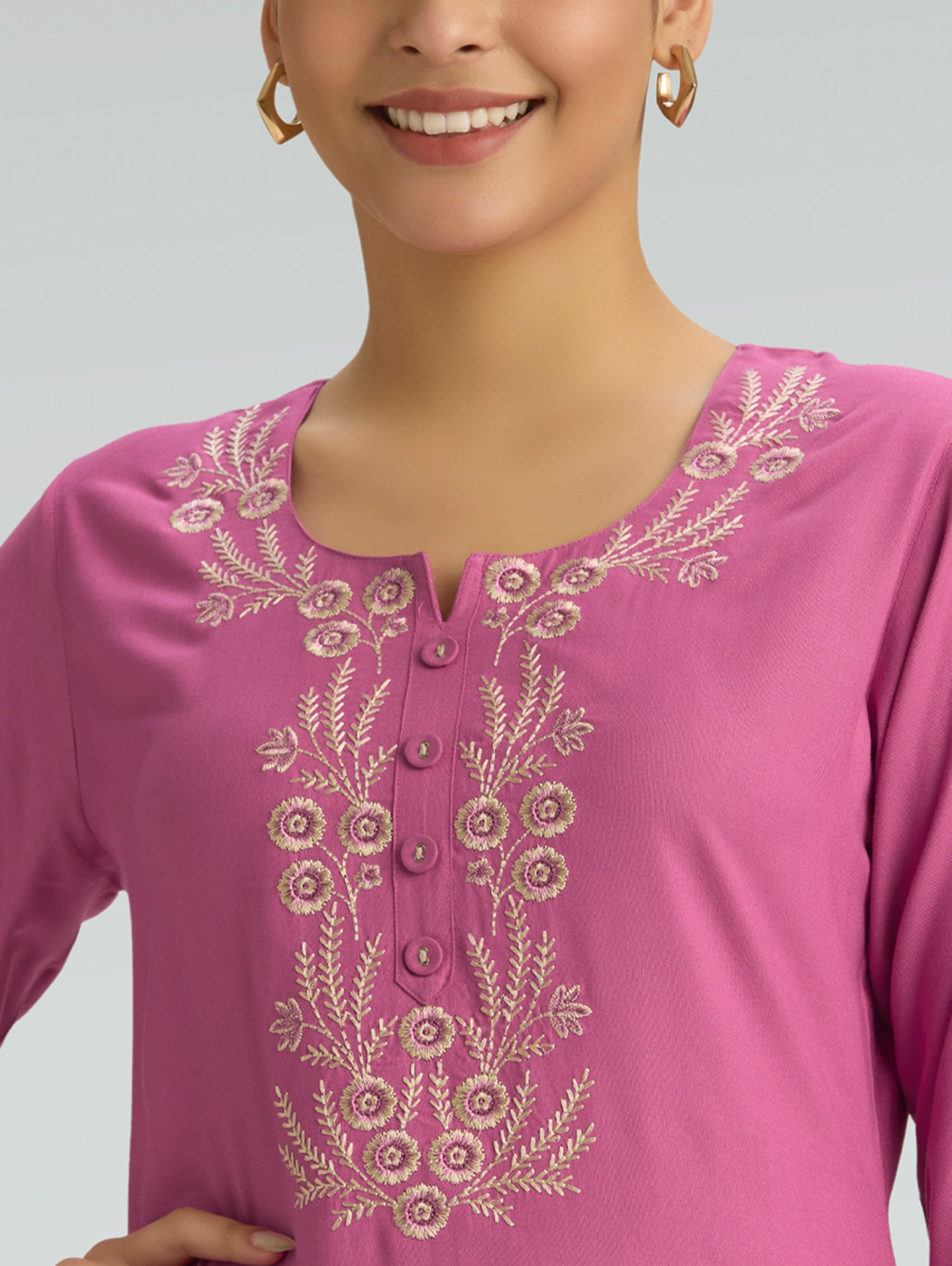 Close-up of a white thread embroidered on a kurta with  plain background