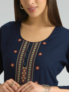 Navy blue top with intricate embroidery on a plain background