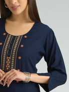 Navy blue top with intricate patterns on a plain background