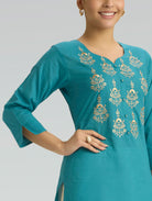 iris blue kurta with gold embroidery on a plain background