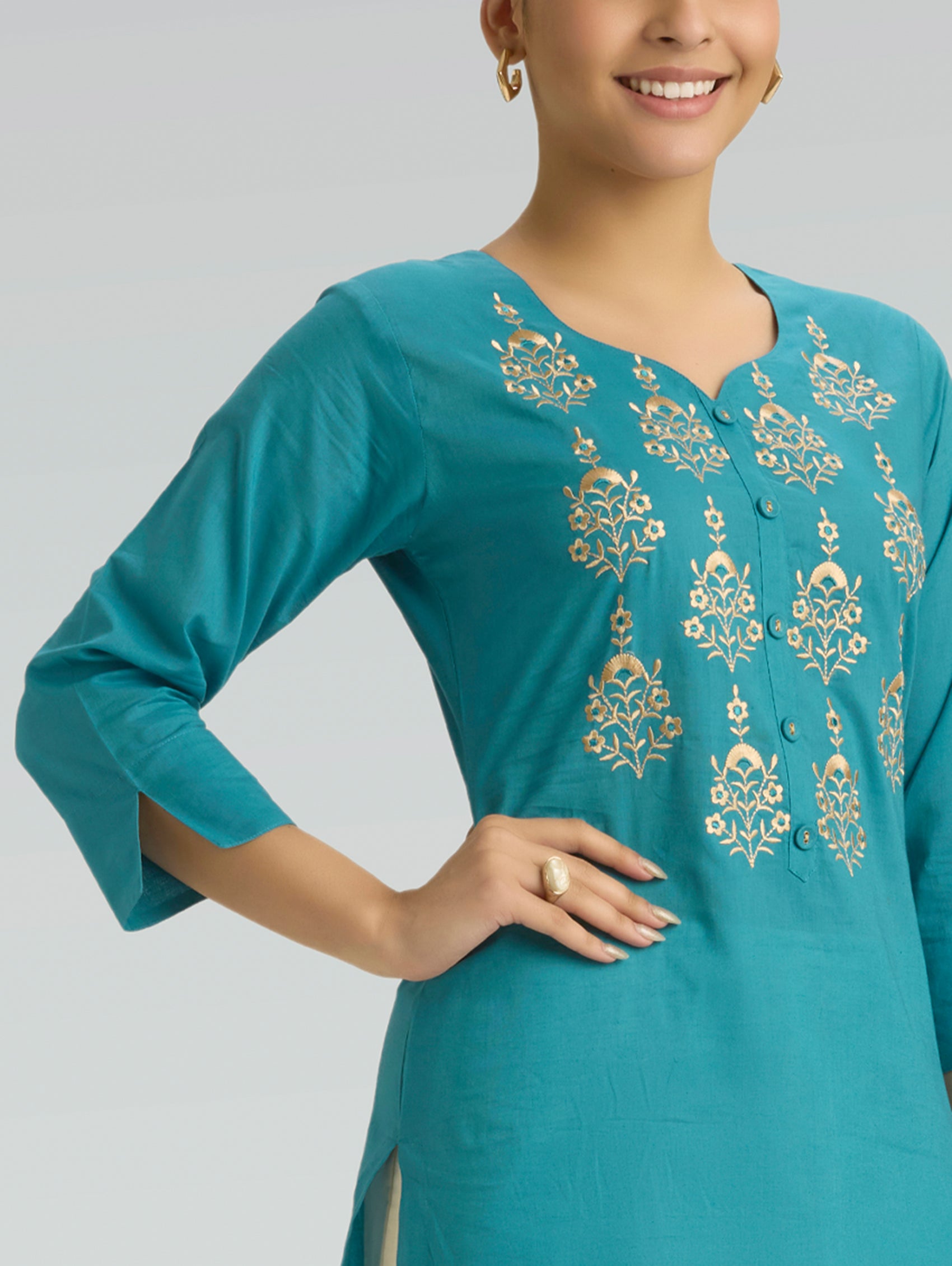 iris blue kurta with gold embroidery on a plain background