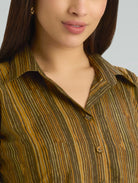 Close-up of a person wearing a patterned shirt with a neutral background