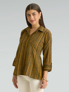 Woman wearing a striped shirt against a plain background