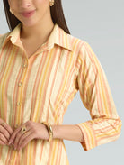 Woman wearing a striped shirt with a neutral background