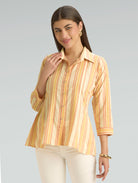 Woman wearing a striped shirt against a plain background