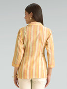 Woman wearing a striped shirt with a neutral background