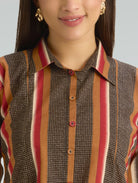 Close-up of a person wearing a patterned shirt with vertical stripes on a plain background