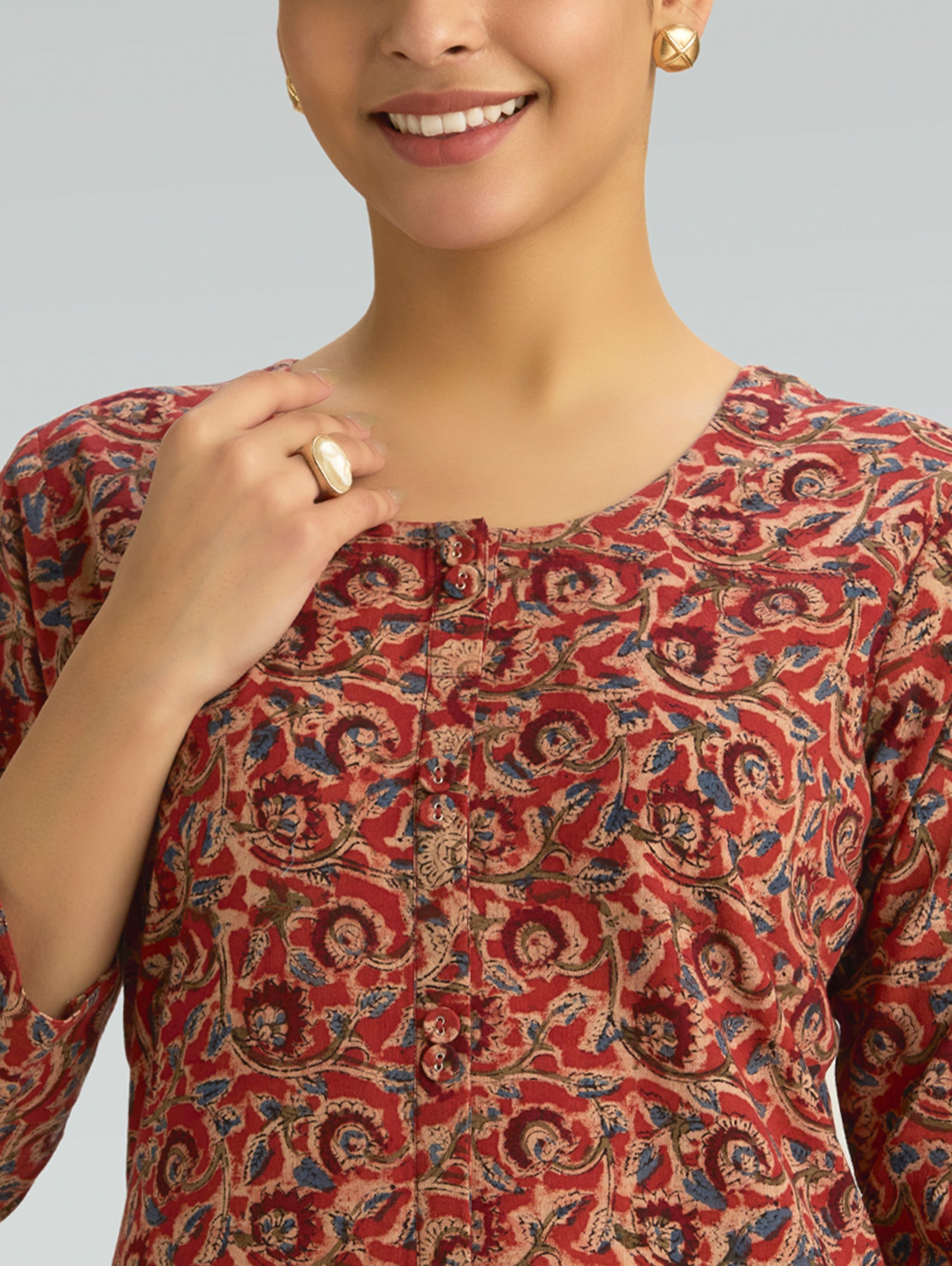 close-up of Kalamkari print and button detailing on a cotton kurta with a round neckline