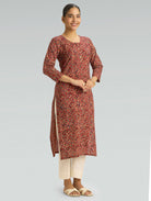 model wearing rust red Kalamkari pure cotton kurta with ivory pants