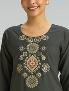 Dark gray long-sleeve top with intricate gold and red embroidery on a plain background