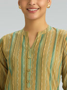 Woman wearing a green and beige striped kurta against a gray background