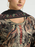 Close-up of a person wearing a patterned garment with intricate designs.