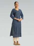 Woman wearing a blue floral patterned kurta on a gray background