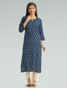 Woman wearing a blue floral dress on a gray background