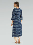 Woman wearing a blue floral dress on a gray background