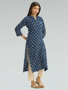 Woman wearing a blue floral patterned dress on a gray background