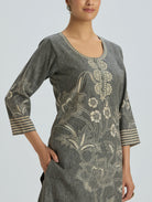 Gray floral embroidered dress with a plain background