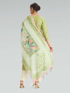 Woman wearing a green and white patterned dupatta on a gray background